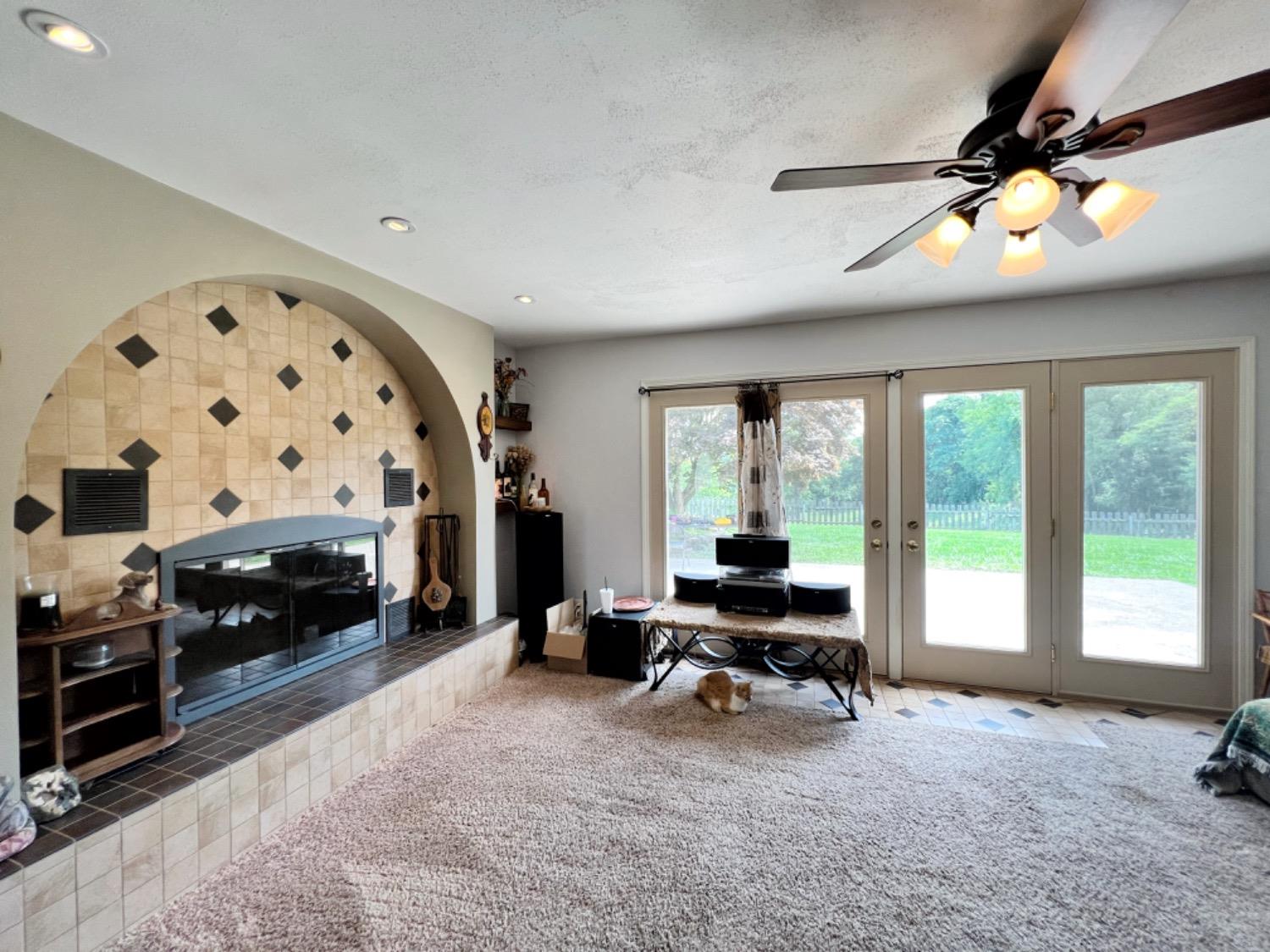 16562 Highway 250 Rising Sun, IN 47040 - Photo 63 of 70 Family room with a wood fireplace and French doors that open to the back patio that is fenced