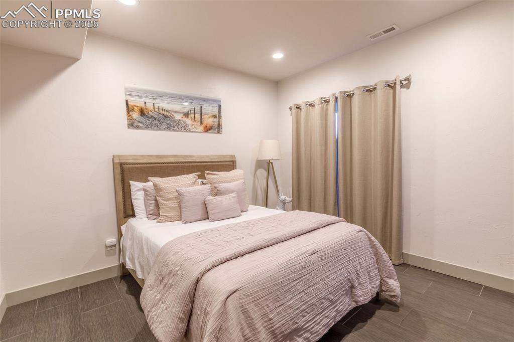 162 Crystal Valley Road Manitou Springs, CO 80829 - Photo 20 of 48 a bedroom with a large bed and a large mirror