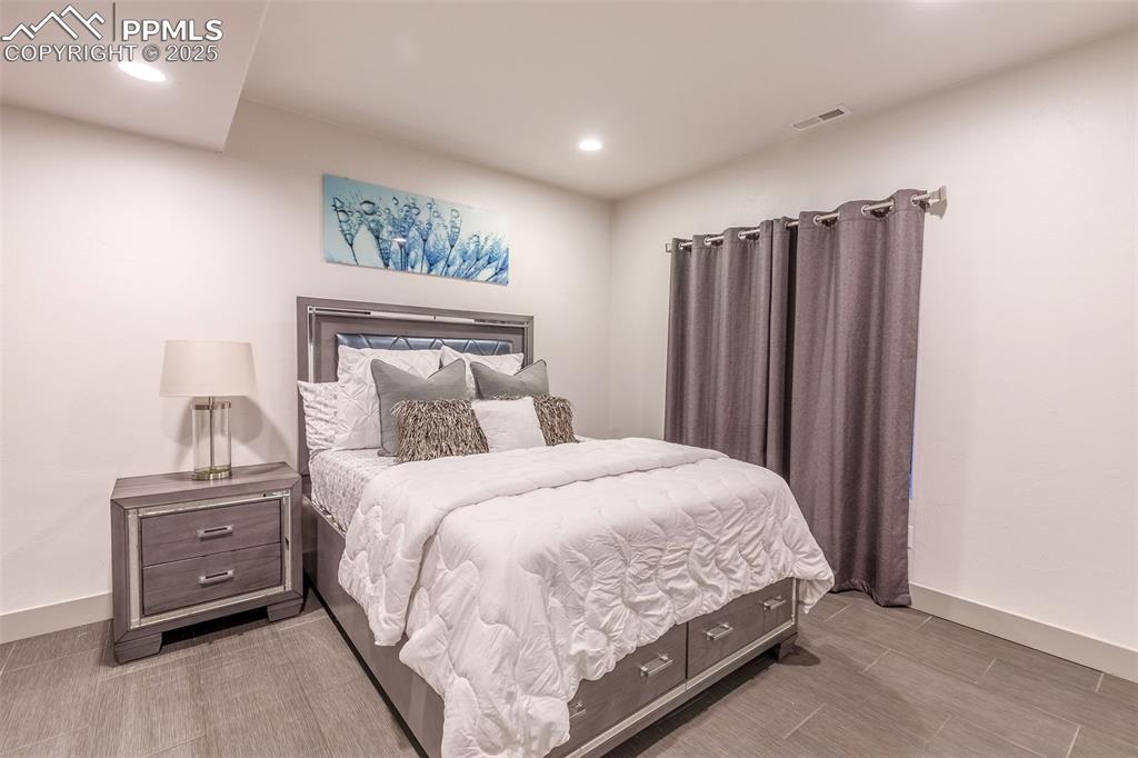 162 Crystal Valley Road Manitou Springs, CO 80829 - Photo 25 of 48 a large bed sitting in a bedroom next to a cabinet