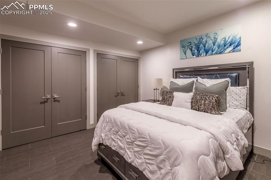 162 Crystal Valley Road Manitou Springs, CO 80829 - Photo 26 of 48 a spacious bedroom with a bed and a chandelier