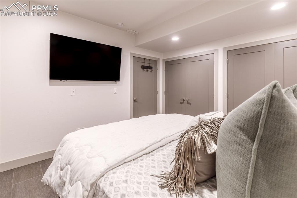 162 Crystal Valley Road Manitou Springs, CO 80829 - Photo 27 of 48 a bedroom with a bed and a flat screen tv