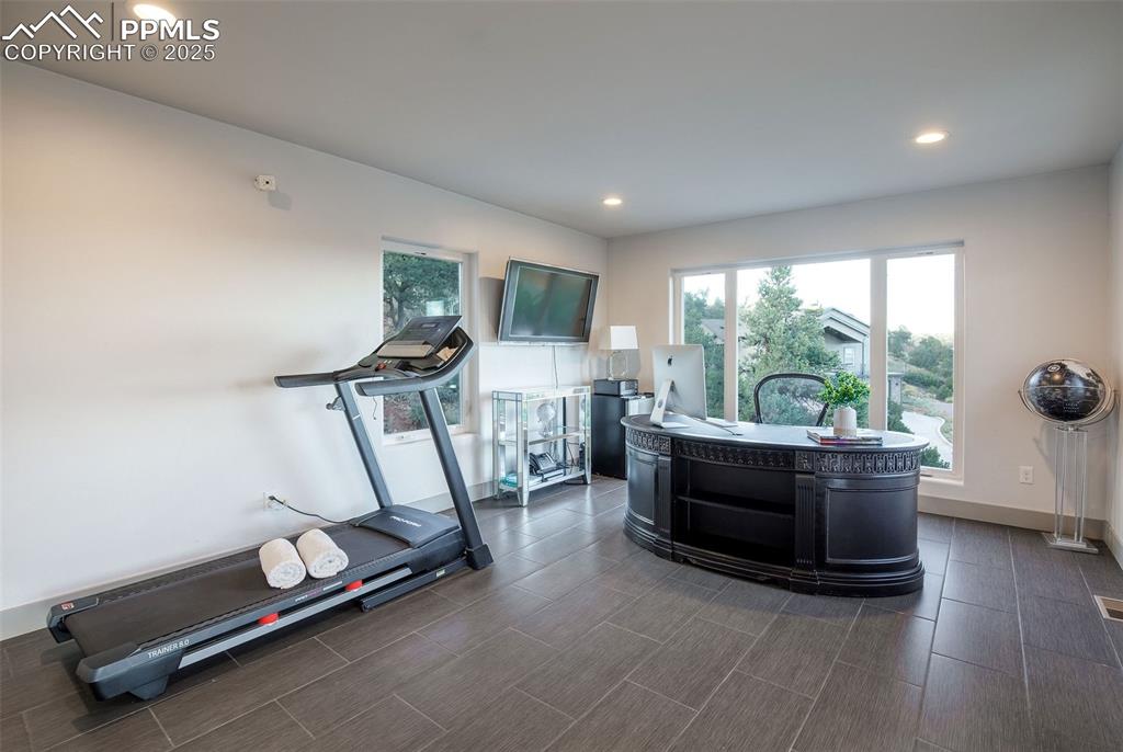 162 Crystal Valley Road Manitou Springs, CO 80829 - Photo 30 of 48 a room with gym equipment and a large window