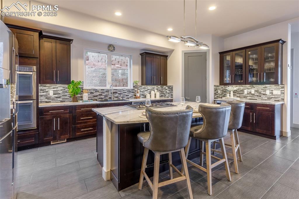 162 Crystal Valley Road Manitou Springs, CO 80829 - Photo 3 of 48 a large kitchen with a table and chairs
