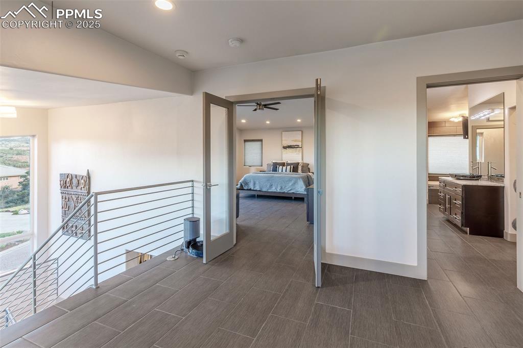 162 Crystal Valley Road Manitou Springs, CO 80829 - Photo 31 of 48 a view of a hallway with a livingroom and a hall with wooden floor