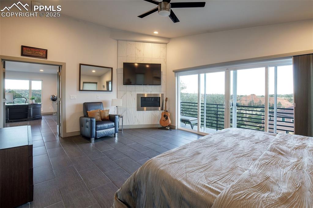 162 Crystal Valley Road Manitou Springs, CO 80829 - Photo 34 of 48 a spacious bedroom with a bed a couch and a large window