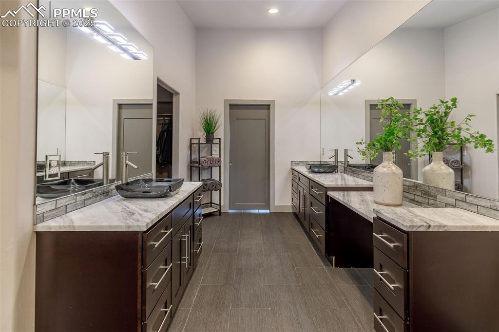 162 Crystal Valley Road Manitou Springs, CO 80829 - Photo 38 of 48 a spacious bathroom with a granite countertop double vanity and a mirror