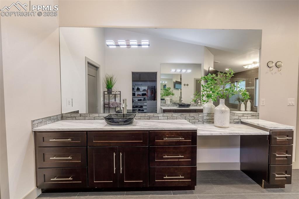 162 Crystal Valley Road Manitou Springs, CO 80829 - Photo 40 of 48 a bathroom with a granite countertop sink a large mirror and a