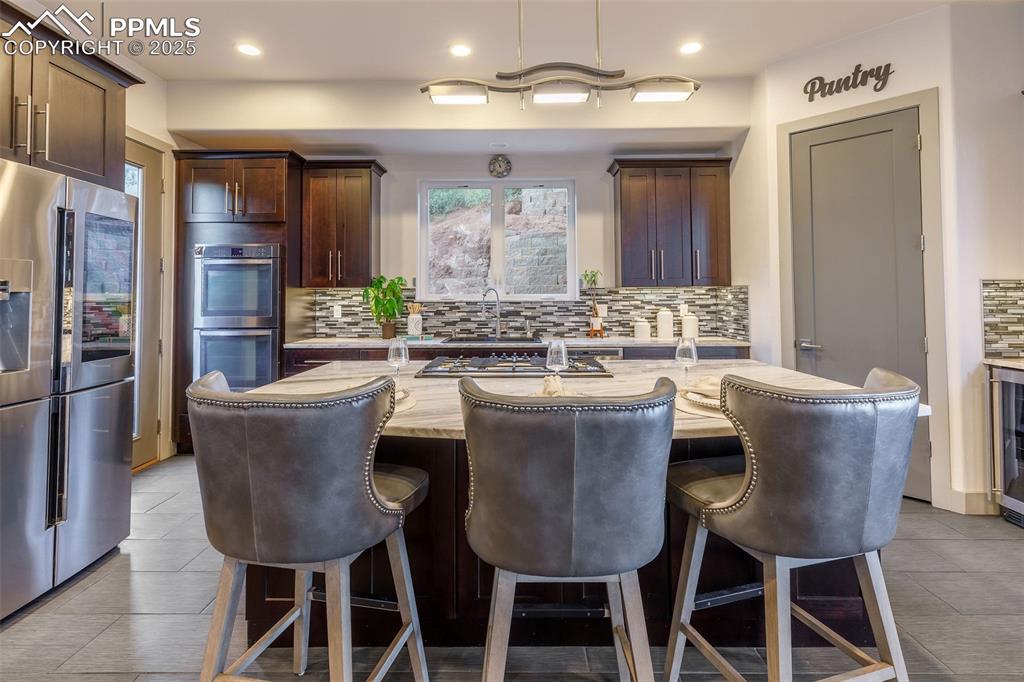 162 Crystal Valley Road Manitou Springs, CO 80829 - Photo 4 of 48 a dining room with furniture a chandelier and window