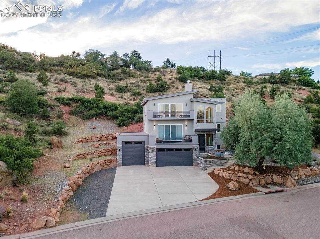 162 Crystal Valley Road Manitou Springs, CO 80829 - Photo 43 of 48 an aerial view of a house with a garden and trees