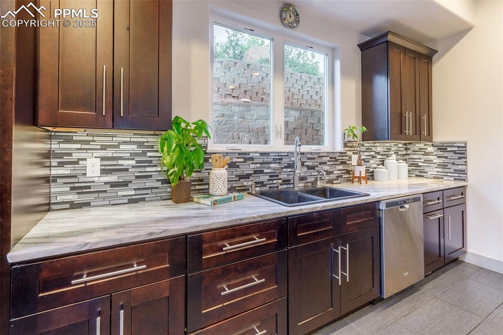 162 Crystal Valley Road Manitou Springs, CO 80829 - Photo 7 of 48 a sink with granite countertop a sink and wooden cabinets