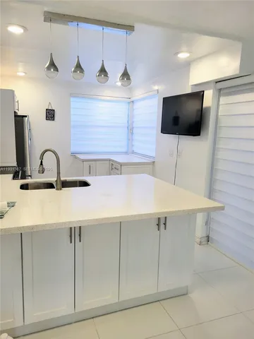 a kitchen with a sink and a microwave