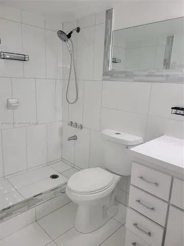 a bathroom with a toilet sink and shower