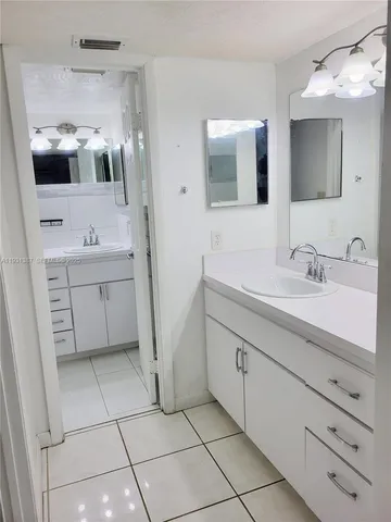 a spacious bathroom with a double vanity sink mirror and