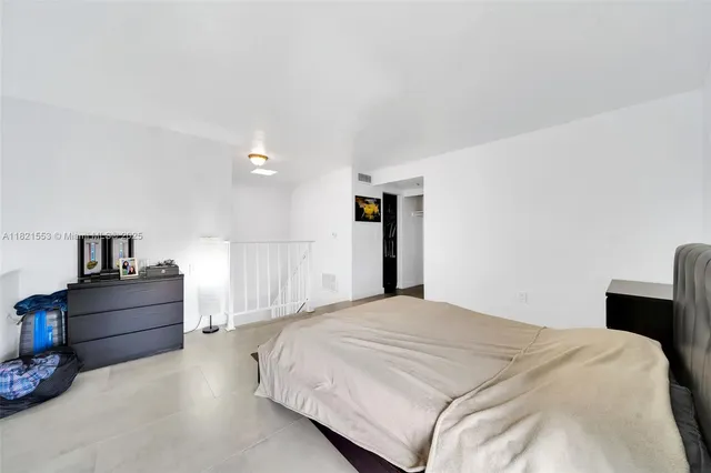 a bedroom with a bed and a desk