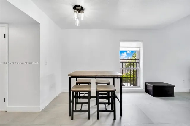 a view of a dining room with furniture and a potted plant