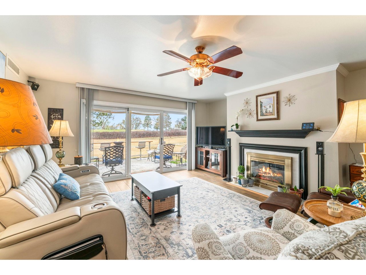 39 Ward Drive, Unit 104 Greeley, CO 80634 - Photo 1 of 31 a living room with furniture a fireplace and a large window