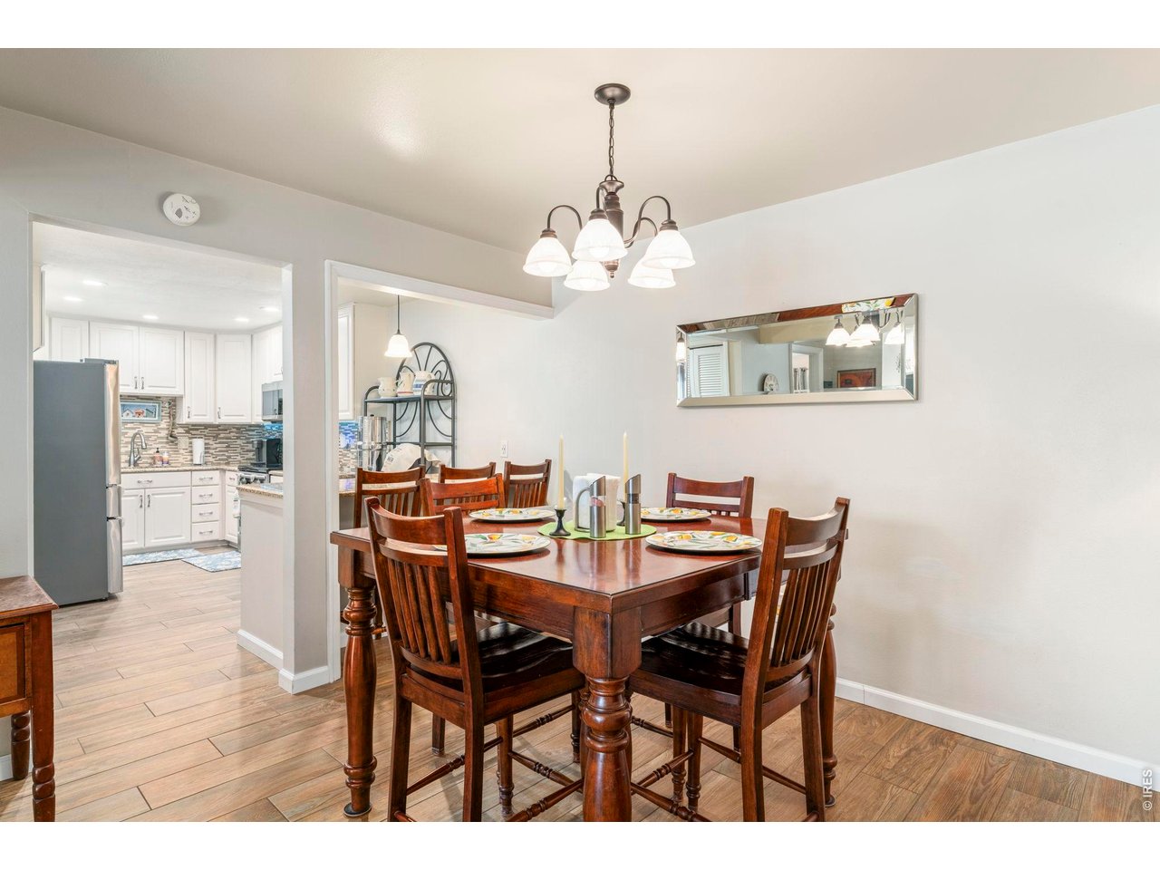 39 Ward Drive, Unit 104 Greeley, CO 80634 - Photo 11 of 31 a view of a dining room with furniture and wooden floor
