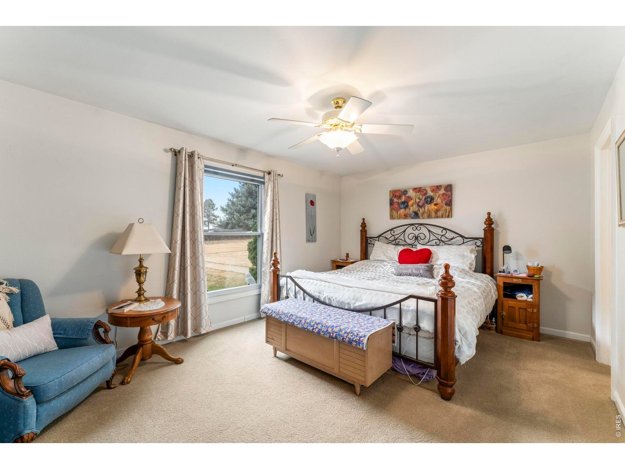 39 Ward Drive, Unit 104 Greeley, CO 80634 - Photo 18 of 31 a bedroom with a bed a couch and a chandelier