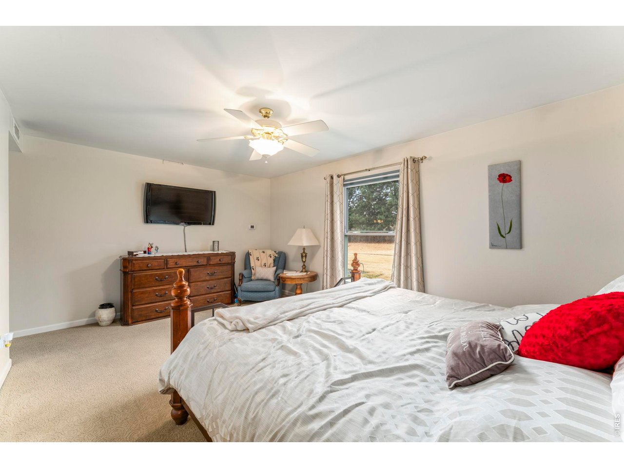 39 Ward Drive, Unit 104 Greeley, CO 80634 - Photo 19 of 31 a bedroom with a bed and a flat screen tv