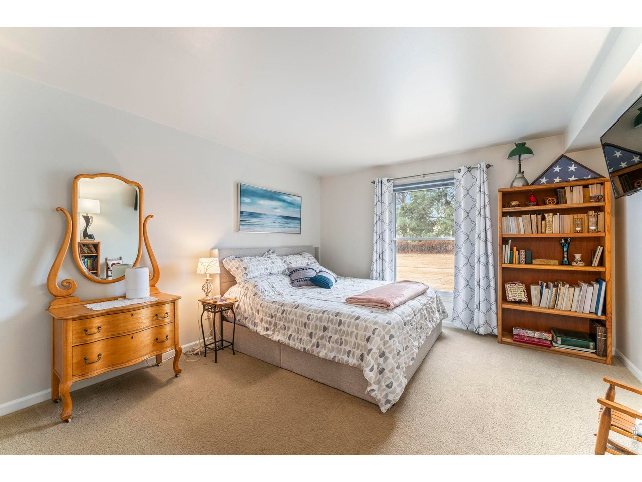 39 Ward Drive, Unit 104 Greeley, CO 80634 - Photo 21 of 31 a bedroom with a bed and dresser