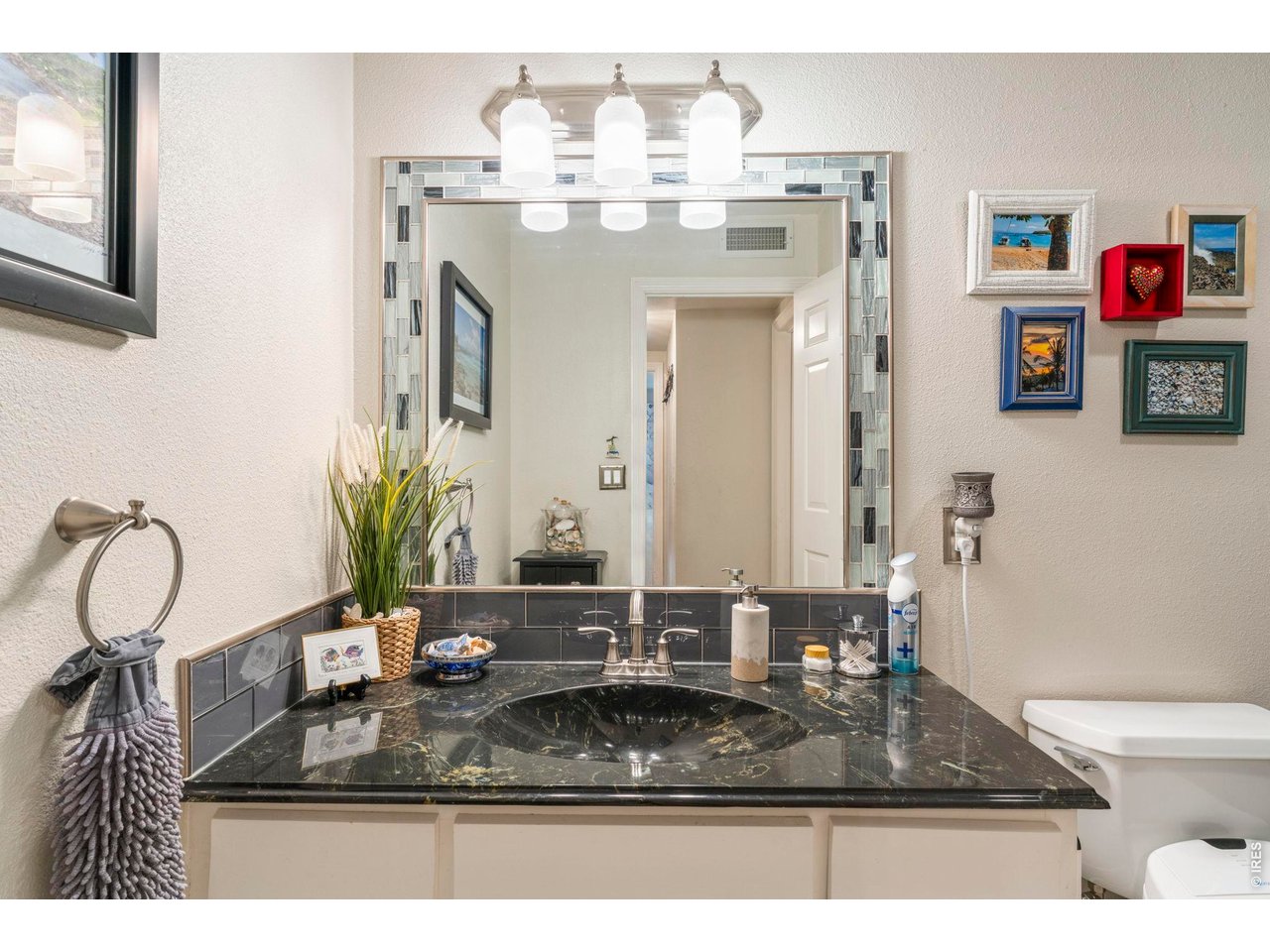 39 Ward Drive, Unit 104 Greeley, CO 80634 - Photo 23 of 31 a bathroom with a granite countertop sink a mirror and shower