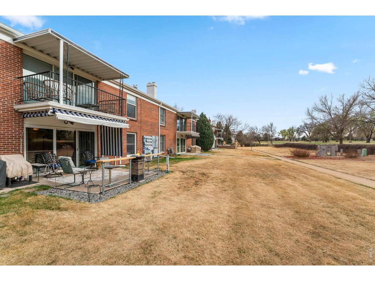 39 Ward Drive, Unit 104 Greeley, CO 80634 - Photo 31 of 31 a swimming pool with outdoor seating and yard