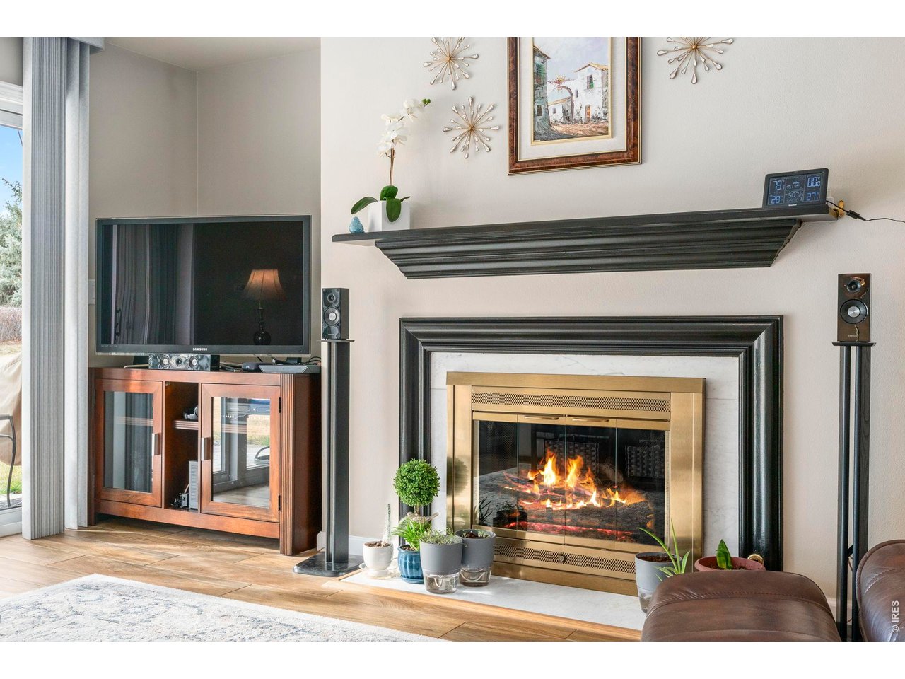 39 Ward Drive, Unit 104 Greeley, CO 80634 - Photo 7 of 31 a living room with a fireplace and a flat screen tv