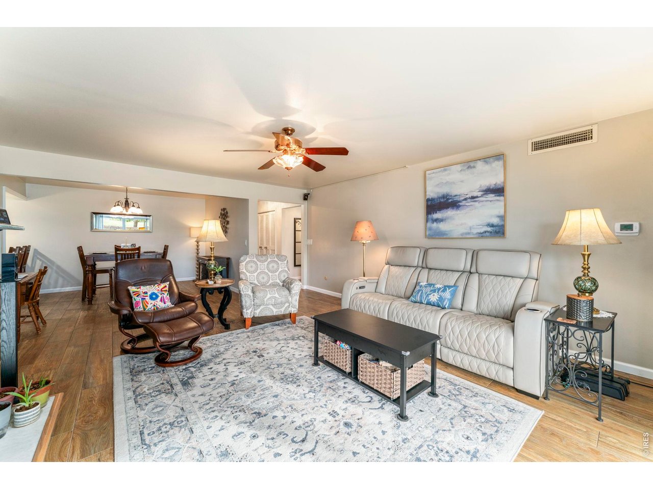 39 Ward Drive, Unit 104 Greeley, CO 80634 - Photo 10 of 31 a living room with furniture and wooden floor