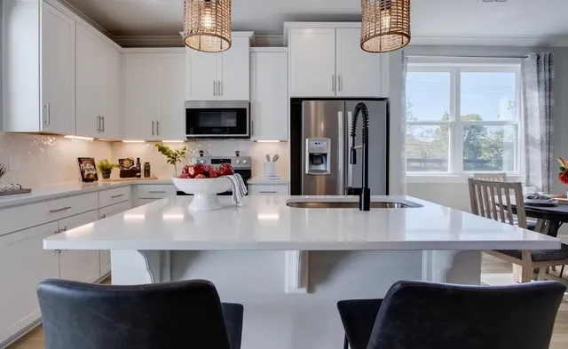 a kitchen with a table chairs refrigerator and microwave