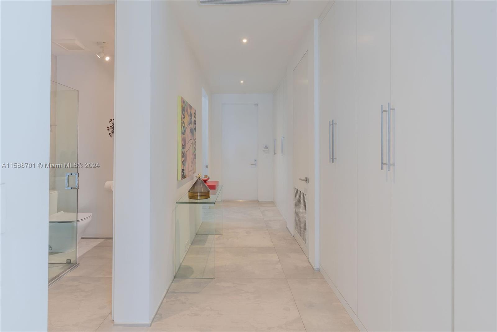 6795 Southwest 113th Street Pinecrest, FL 33156 - Photo 11 of 30 a view of a hallway with wooden floor and windows