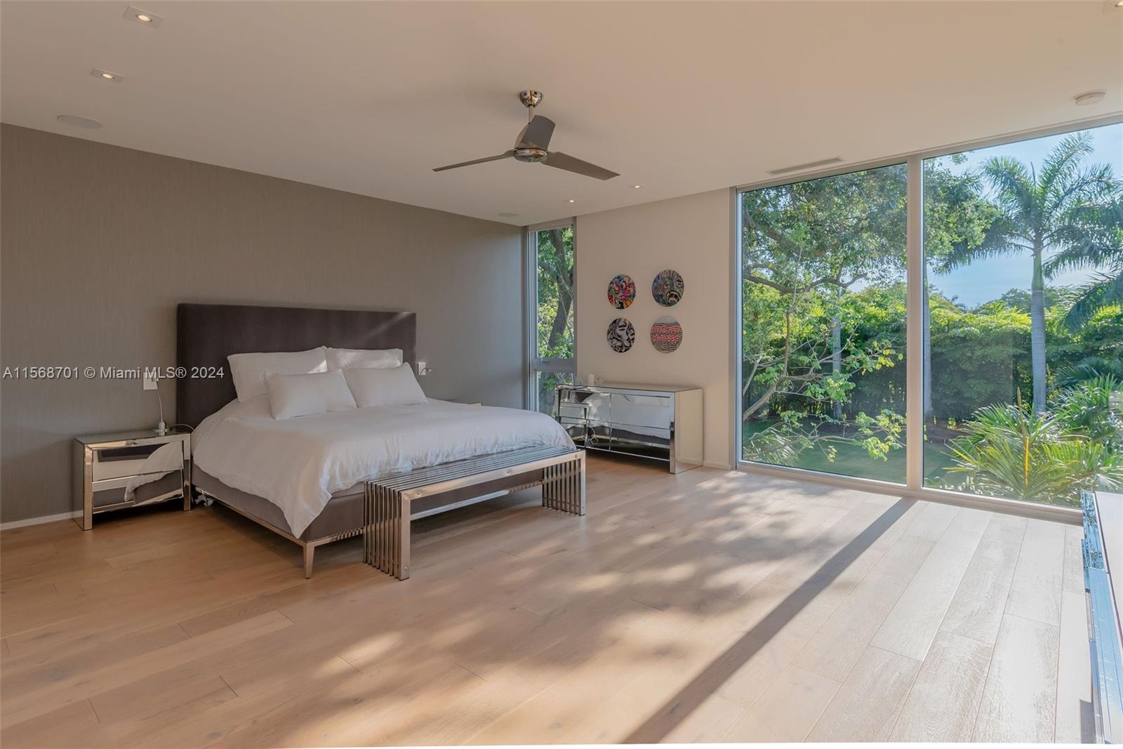 6795 Southwest 113th Street Pinecrest, FL 33156 - Photo 14 of 30 a bedroom with a bed and a large window