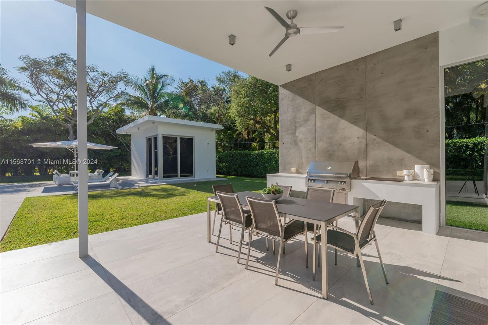 6795 Southwest 113th Street Pinecrest, FL 33156 - Photo 19 of 30 a view of house with swimming pool yard and outdoor seating
