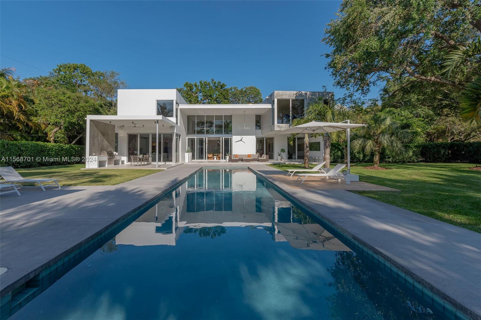 6795 Southwest 113th Street Pinecrest, FL 33156 - Photo 23 of 30 a house view with a seating space and garden view