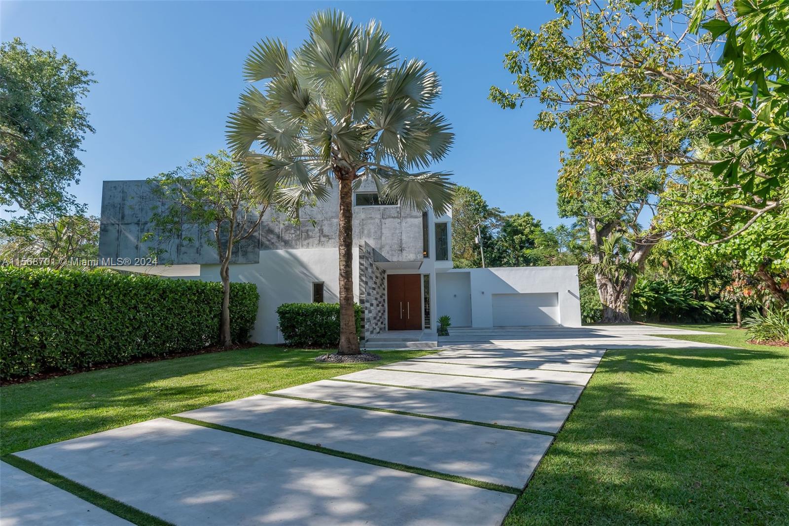 6795 Southwest 113th Street Pinecrest, FL 33156 - Photo 26 of 30 a front view of a house with a yard