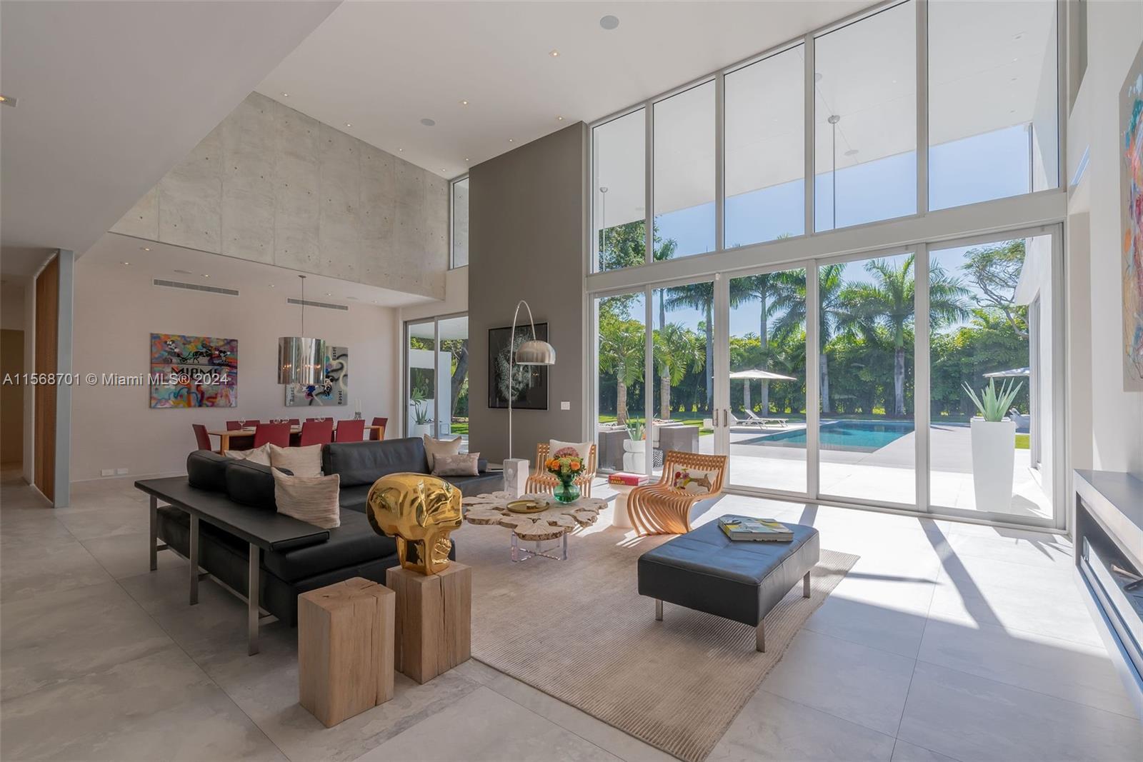 6795 Southwest 113th Street Pinecrest, FL 33156 - Photo 5 of 30 a living room with furniture and floor to ceiling windows