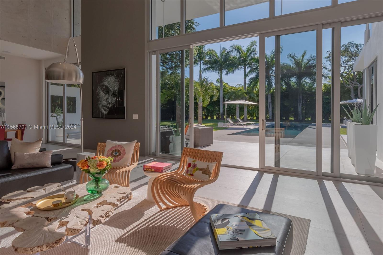 6795 Southwest 113th Street Pinecrest, FL 33156 - Photo 6 of 30 a living room with furniture and a large window