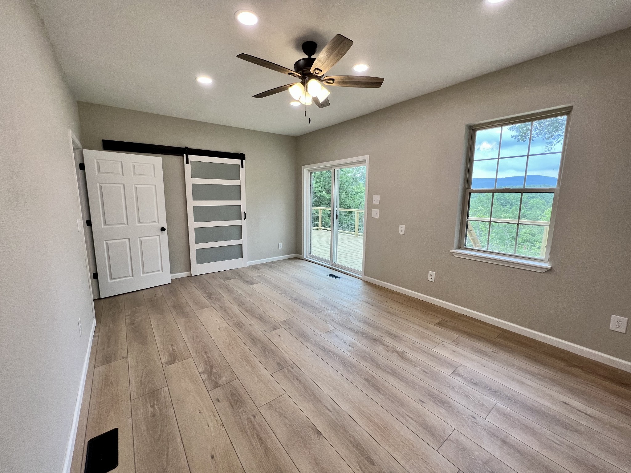 1668 Russell Ridge Road Crossville, TN 38555 - Photo 17 of 38 a view of an empty room with a window and wooden floor