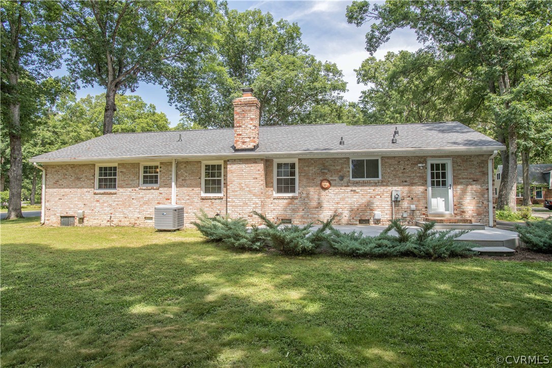 1620 Featherstone Drive Midlothian, VA 23113 - Photo 5 of 29 a front view of a house with a garden and trees