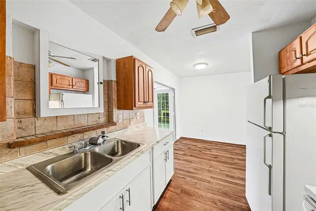 a kitchen with a sink and a refrigerator