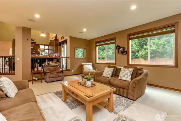 a living room with furniture and large windows