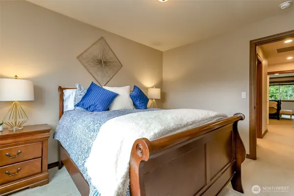 a bedroom with a bed and a night stand