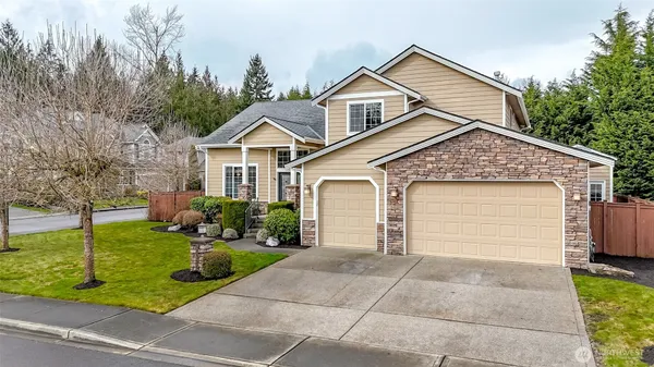 a front view of a house with a yard and garage