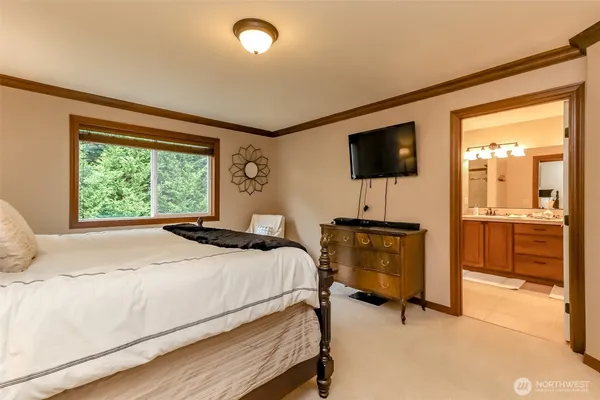 a bedroom with a bed and a television