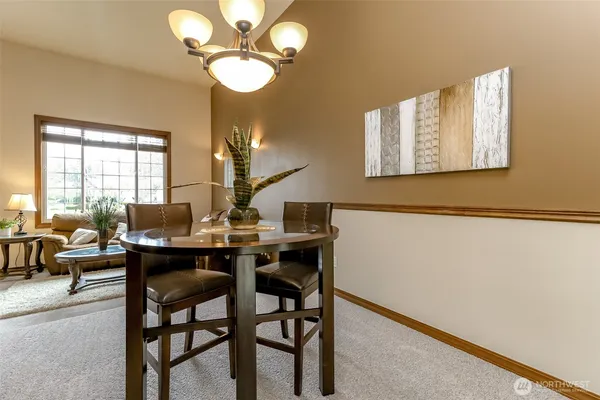 a view of a dining room with furniture and chandelier