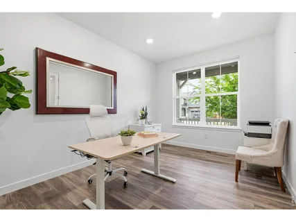 a workspace with furniture and a potted plant