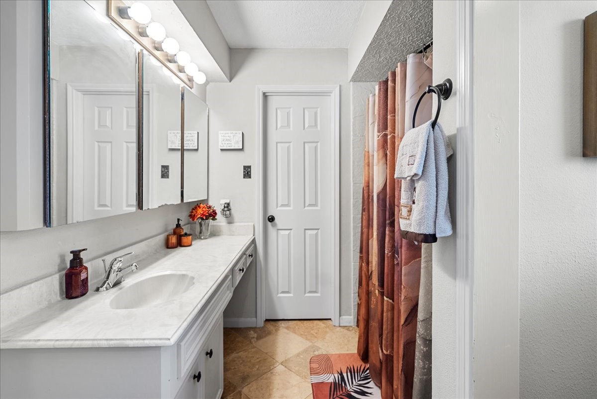 7111 Tonkawa Street Baytown, TX 77521 - Photo 14 of 23 a bathroom with a sink and a mirror