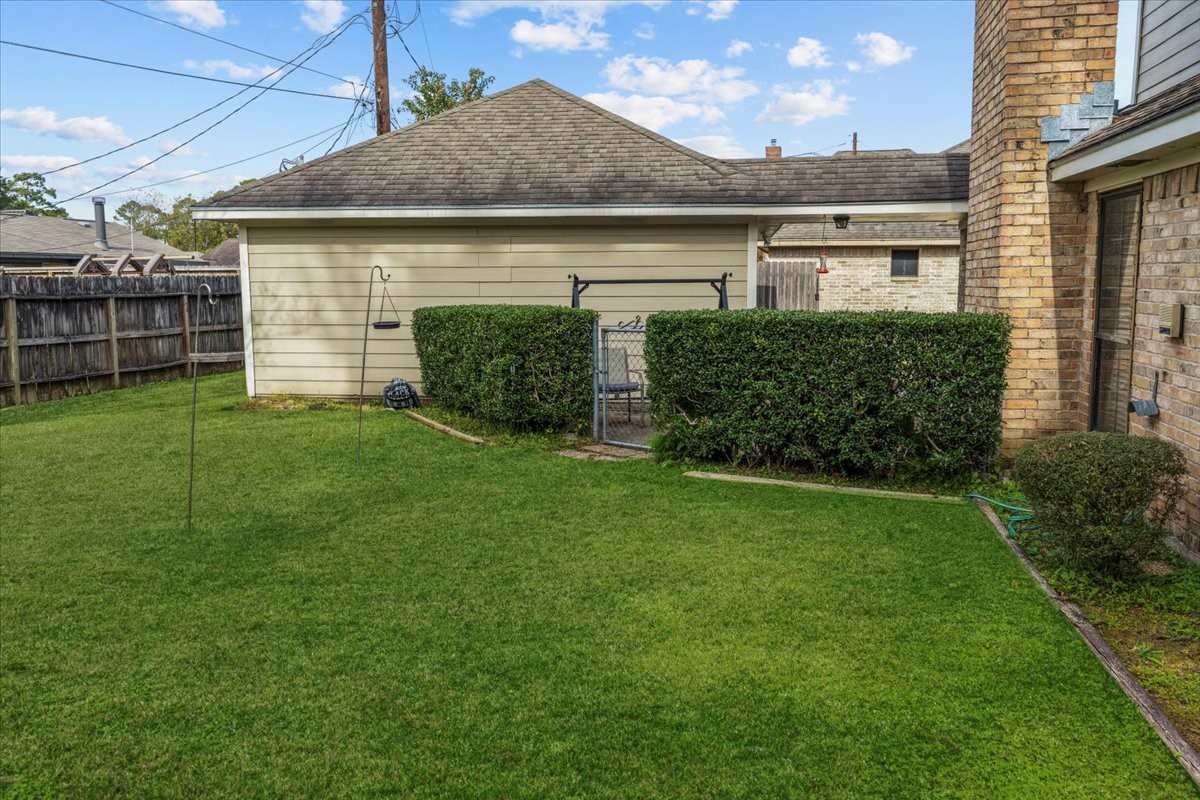 7111 Tonkawa Street Baytown, TX 77521 - Photo 5 of 23 a front view of a house with a garden