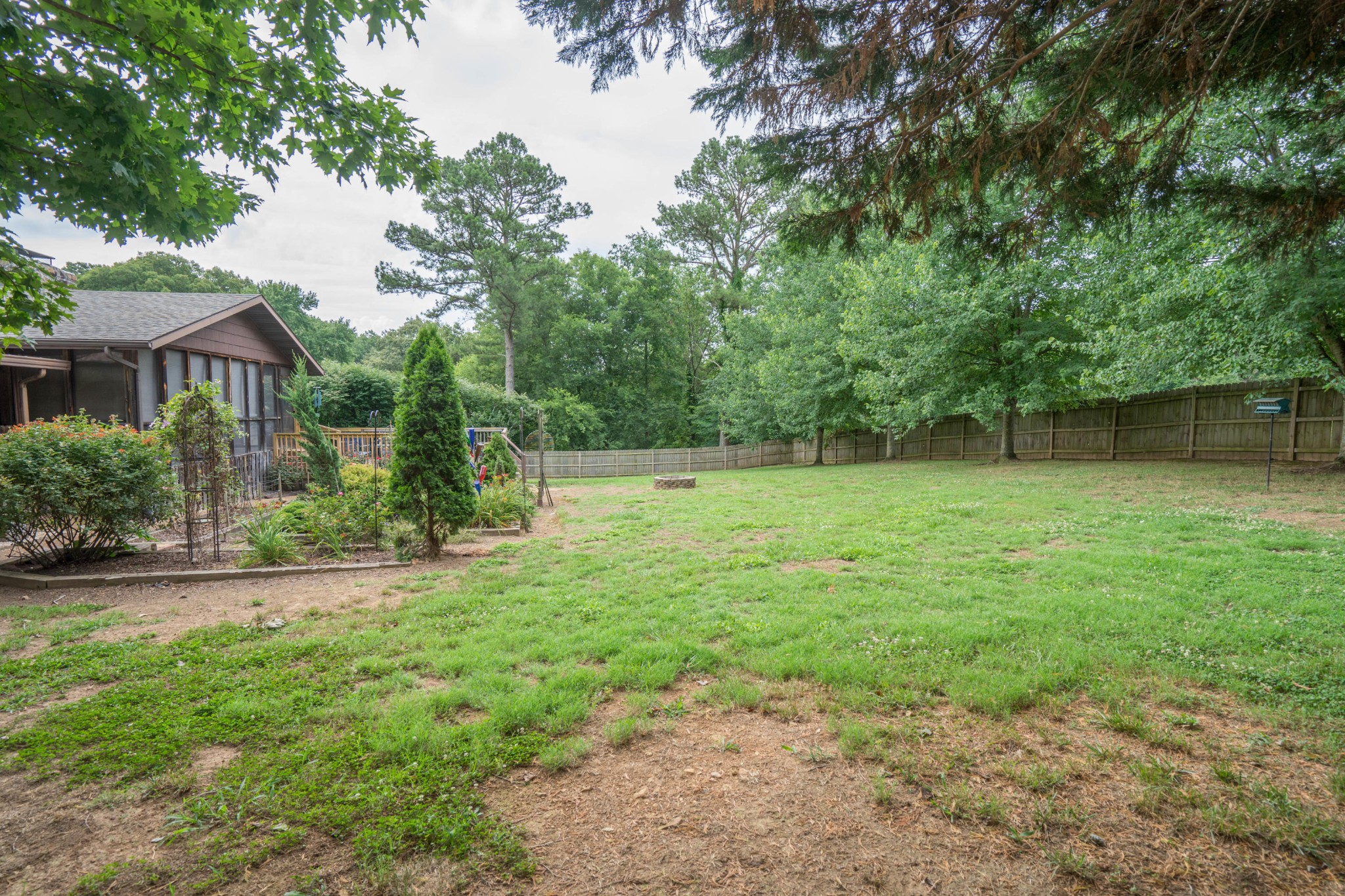 441 Orchard Knob Road Clinton, TN 37716 - Photo 31 of 33 a view of a backyard with a garden