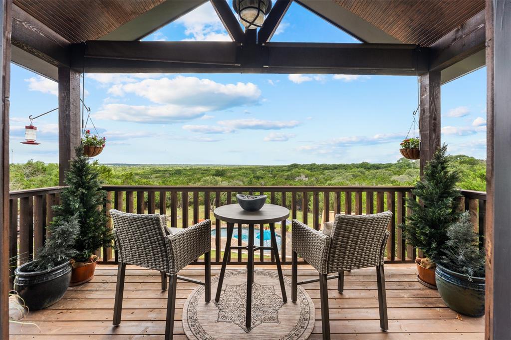 124 Bluffview Circle China Spring, TX 76633 - Photo 29 of 40 Balcony off Primary bedroom featuring a wood-finish deck and ceiling, exposed structural beams, and traditional railing