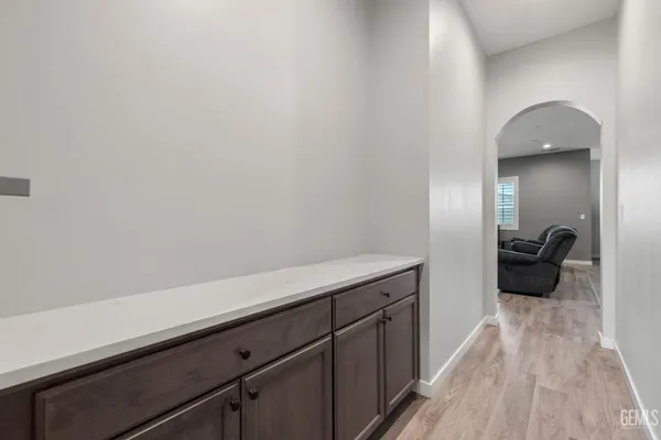 a living room with furniture and a dining table with kitchen view